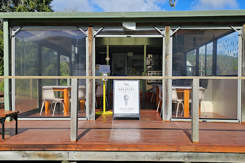 Sun shines on table and chairs in the eating area of the Kiosk